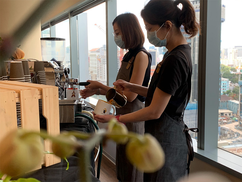 Jasmine Xu (L) and Bonnie Chin (R) creating specialty coffee drinks during the Lunar New Year event.