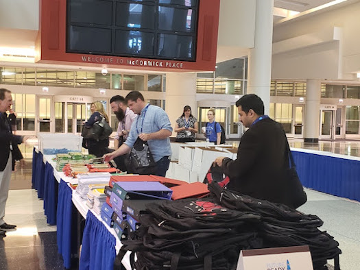 Photo of volunteers manning school supplies table