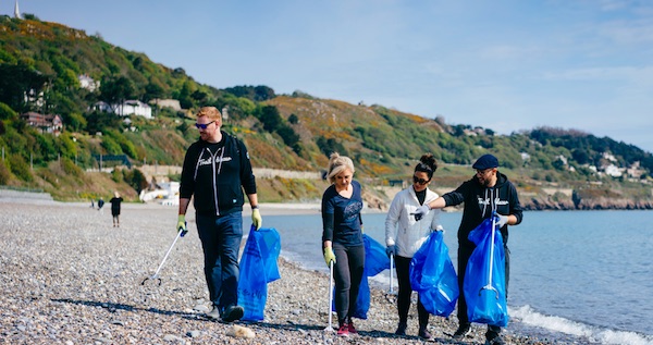 Earthforce volunteers at a beach clean-up personifying the #trashtag challenge