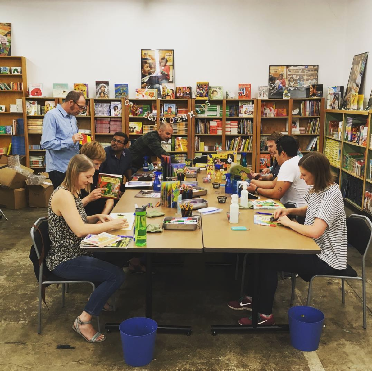 Idealist Consulting employees volunteer at Portland-based Children’s Book Bank to help repair children’s books.