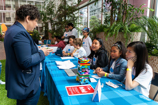 Children manning a table at a maker fair onsite at Salesforce San Francisco