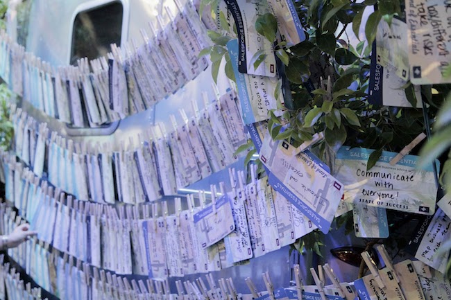 Small business advice from Dreamforce attendees fill cards that cover the side of an Airstream trailer.