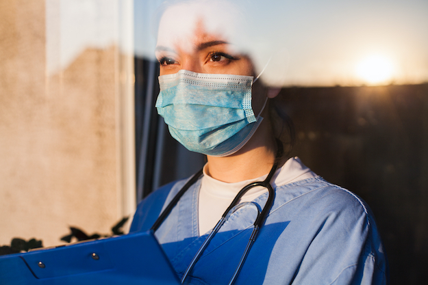 Woman wearing face mask and medical protective gear