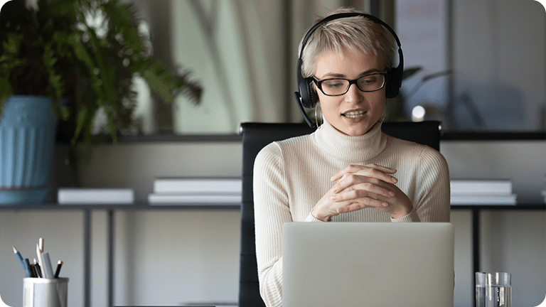 A B2B sales employee working on a laptop