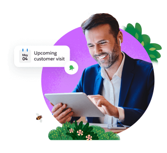 Smiling man holding tablet with a notification for an upcoming customer visit.