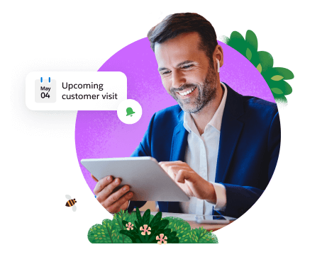 Smiling man holding tablet with a notification for an upcoming customer visit.