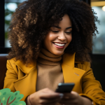Woman in a jacket checking her phone and smiling / email deliverability