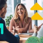 Three B2B salespeople sitting at a table talking and smiling
