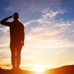 Silhouette of soldier saluting