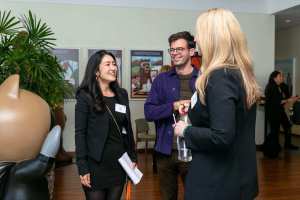 An event photo from Salesforce Startup Summit including attendees collaborating over GTM strategies.