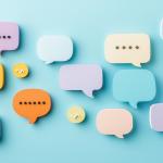 Illustration of several speech bubbles in color on a blue background simulating team communication.