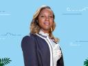 #AskTheTrailblazer host Jaylena Lomenech stood against a blue background with greenery and clouds.