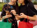 Two shoppers use their mobile phones to purchase items: shoppable content