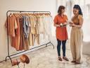 Photo of a saleswoman and a customer in a boutique clothing store, looking at a tablet / zero copy integration