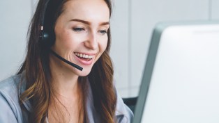 Customer service rep with headset responding to enquiry