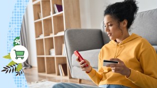 Female shopper holding phone with credit card