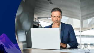 Man sits at laptop.