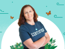 Salesforce-certified Instructor, Tani Long, standing in her certified T-shirt against a floral background