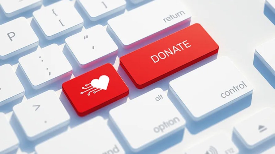 A keyboard that highlights the word "Donate" with a red heart next to it