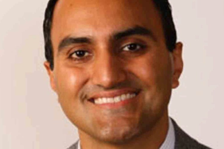 Photo of Adnan smiling