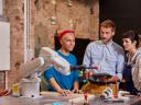 People working with robotic arm
