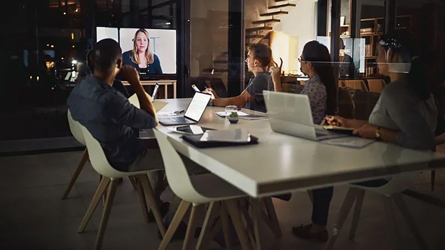 A group of people seated at a table in a virtual meeting.