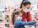 a woman and a child pick out socks in a retail store