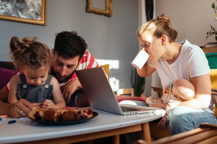 Parents managing children and working from home simultaneously
