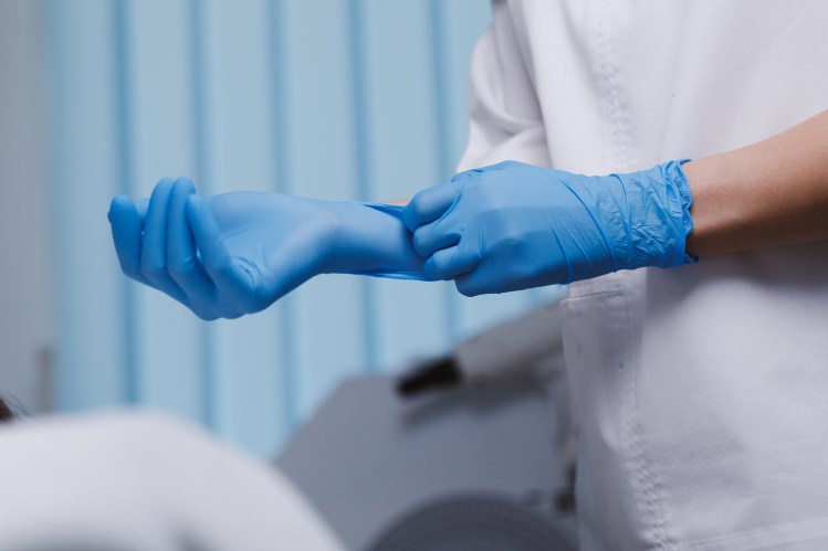 Doctor Wearing Sterile Glove