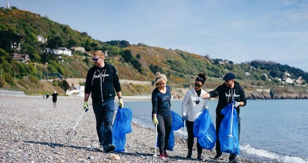 Earthforce volunteers at a beach clean-up personifying the #trashtag challenge