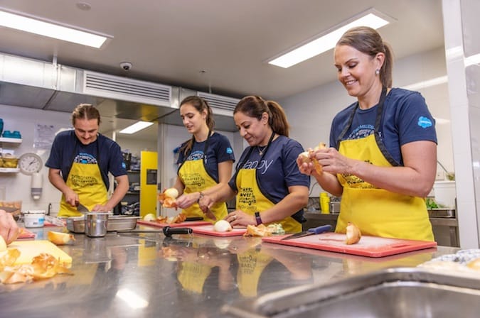 Photo of Salesforce employees prepping food at a volunteer event