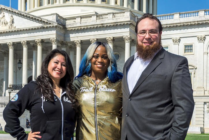Shonnah Hughes, Stephanie Herrera, and Zac Otero pose in front of the Capitol Building