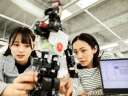 2 women working with robotics