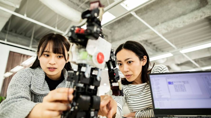 2 women working with robotics
