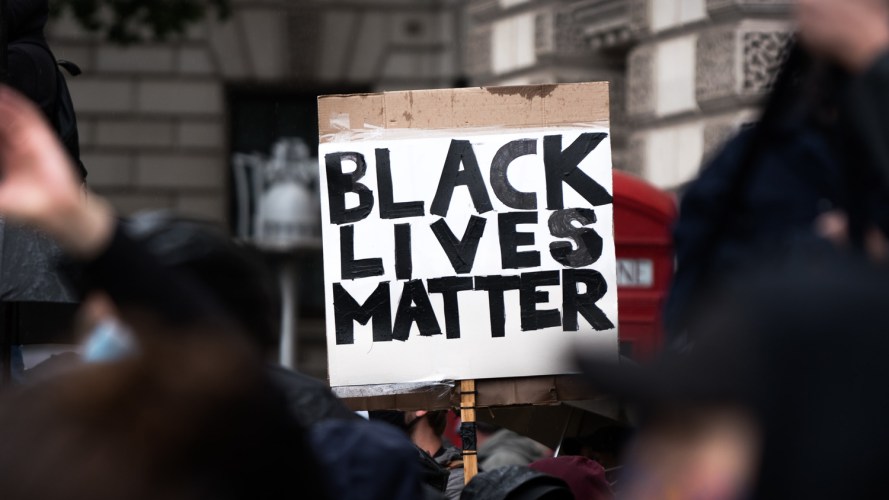 handwritten Black Lives Matter sign in crowd