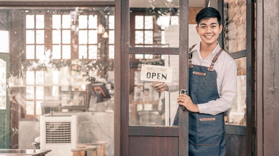 Man opening his shop - smb or small and medium business growth