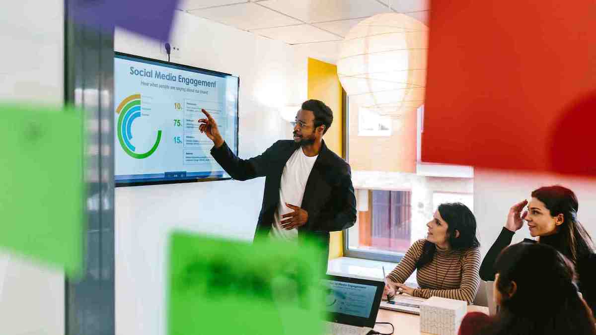 Man gives a presentation to colleagues