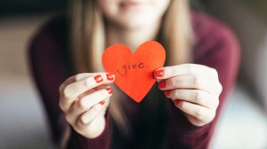 girl holding a paper heart