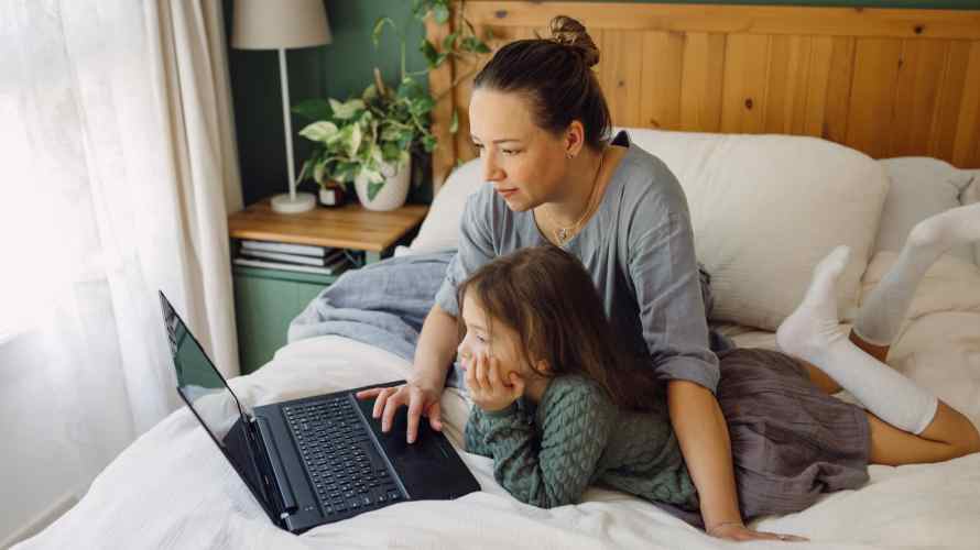Mother and daughter viewing a laptop