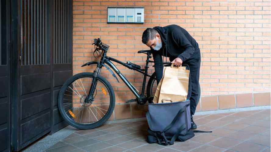 Delivery person on a bicycle as an example of how retail is changing