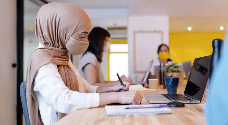 Woman in hijab working at her desk