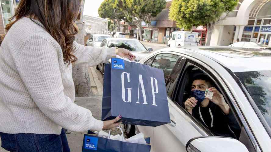 GAP worker takes a package to a customer waiting curbside