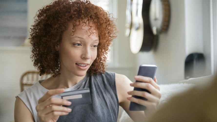 Woman poised to make a purchase on her mobile device