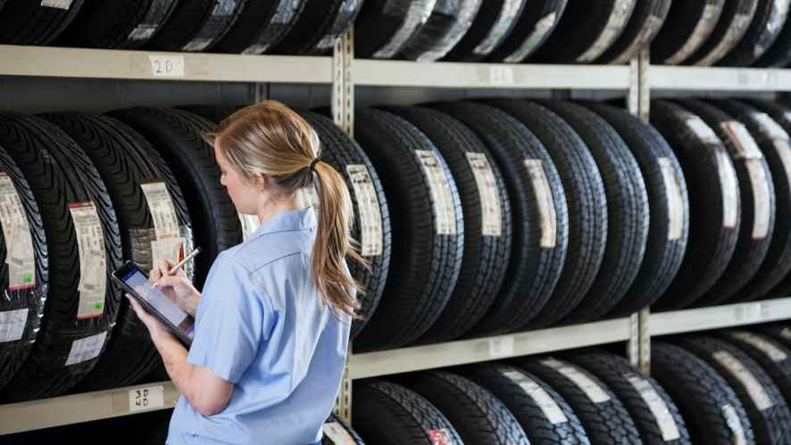 Woman taking inventory on tires