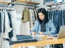 Woman works on her CRM system in a retail store