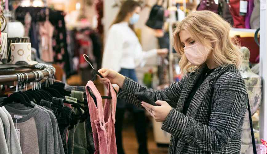 Female shopper glances at her phone