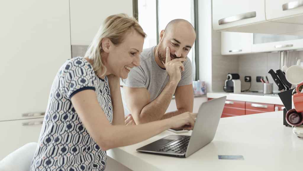 Couple checking at something on their laptop