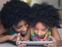 woman and child looking at a smart tablet together: streaming wars, subscription fatigue