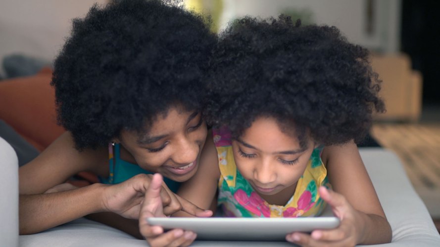 woman and child looking at a smart tablet together: streaming wars, subscription fatigue