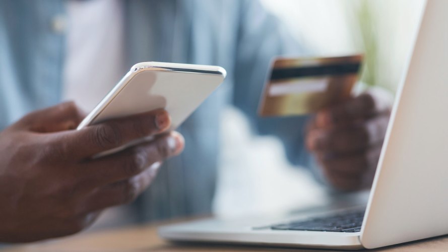 Man uses credit card to complete purchase on his mobile